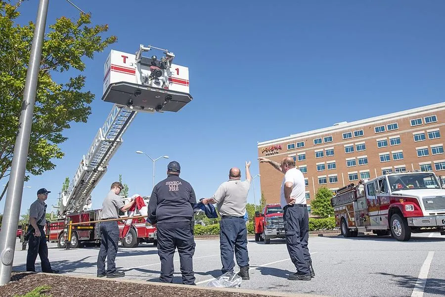 Firefighters raising an American flag